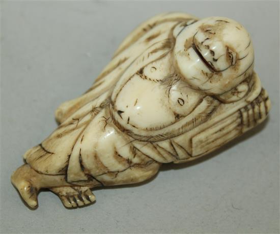 A Japanese ivory netsuke of Hotei, 18th / 19th century, 5.5cm, age cracks